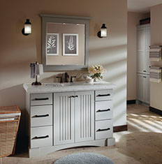 grey bathroom vanity with mirror hung above