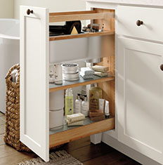 white bathroom cabinet pullout with products placed on shelves inside