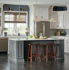 kitchen island with two wooden barstools in cool toned kitchen